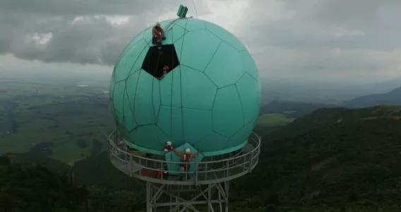 Avalon crew members perform maintenance on a transmitter tower dome